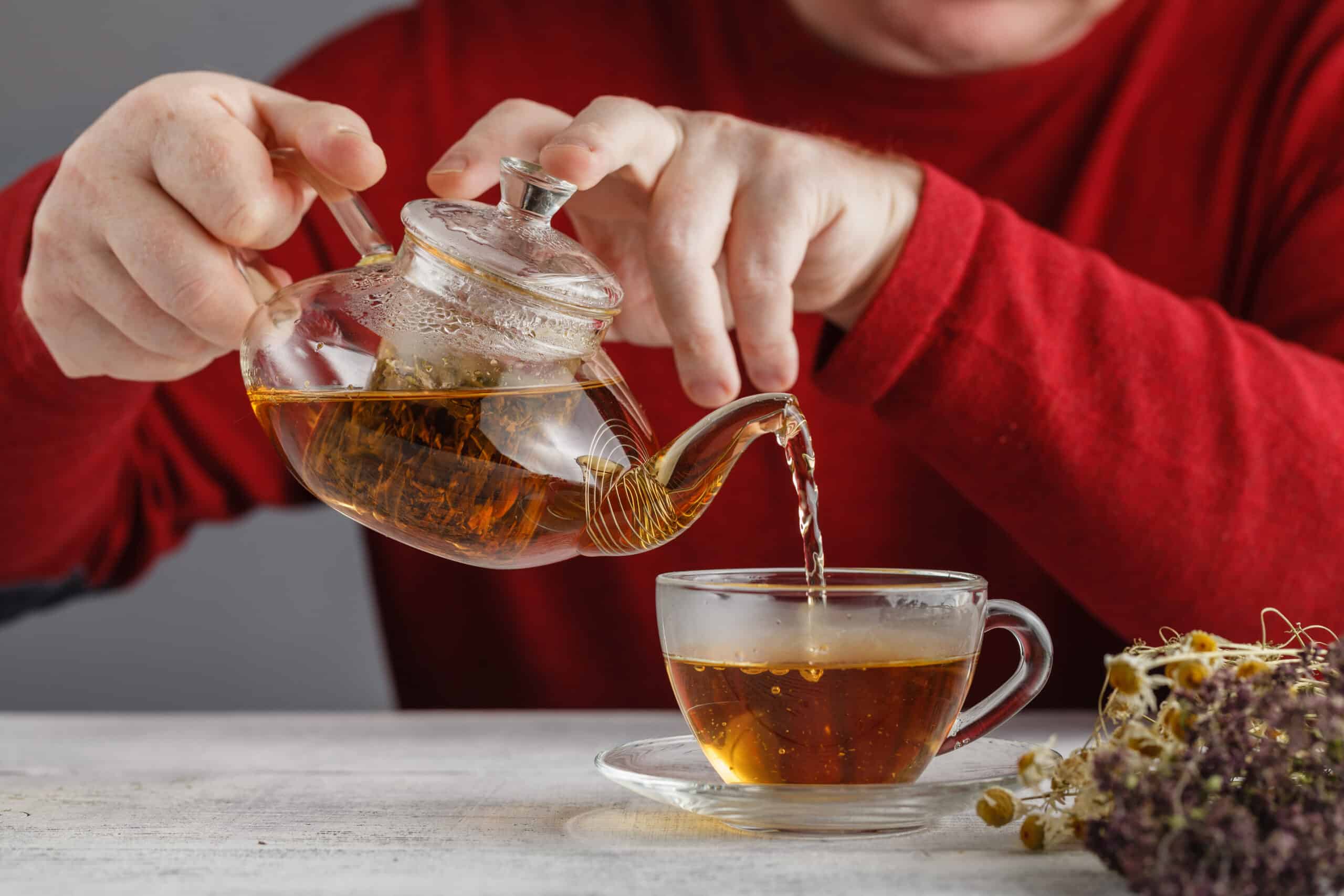 side view of a male pouring tea